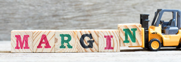 Toy forklift hold letter block N to complete word margin on wood background