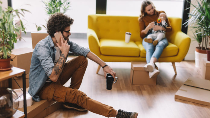 Dad talking on the phone with delivery service providers millennial home layout