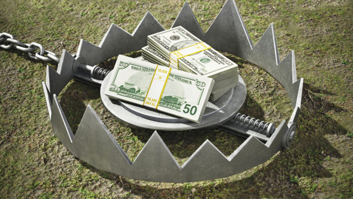Dollar bills standing at the middle of open bear trap