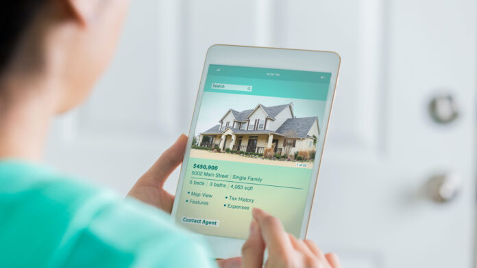 Woman uses digital table to search for new home home prices